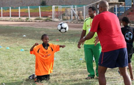 Tony Sanneh works on header techniques with a young Ethiopian.