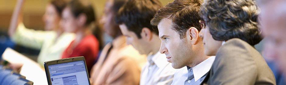 Photo of man and woman looking at computer