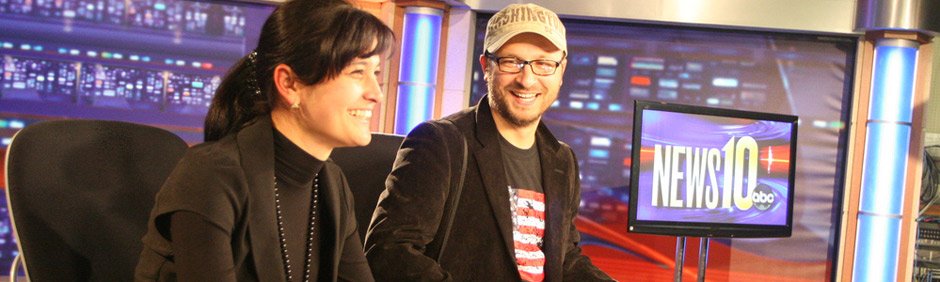 Man and woman sitting at a television news desk