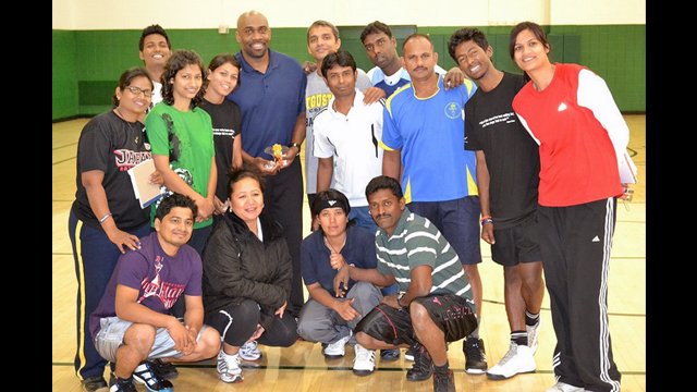 The group poses after a basketball session with Coach Joe Touomou, former Georgetown player.