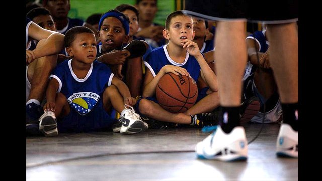 Young Venezuelans listen intently as Greivis Vasquez describes the determination and hard work that go into becoming a better player.