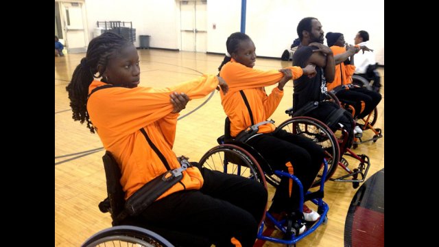 The Senegalese delegation stretches before participating in a disability sport activity with members of a wheelchair basketball league in Washington, D.C.