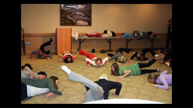 The group stretches with national team members including Matt Ladley, winner of the Grand Prix, and Spencer Tamblyn, US National Team coach.
