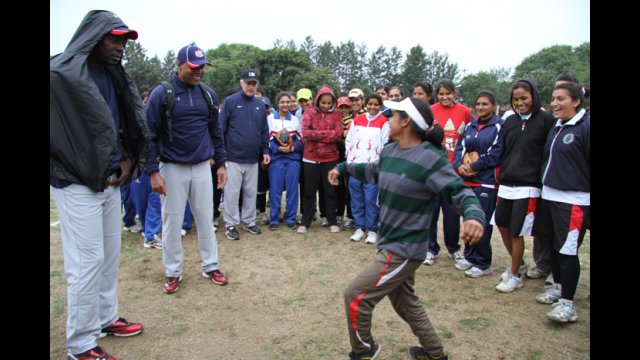 A young Indian woman demonstrates her dancing skills to peers and the envoys.