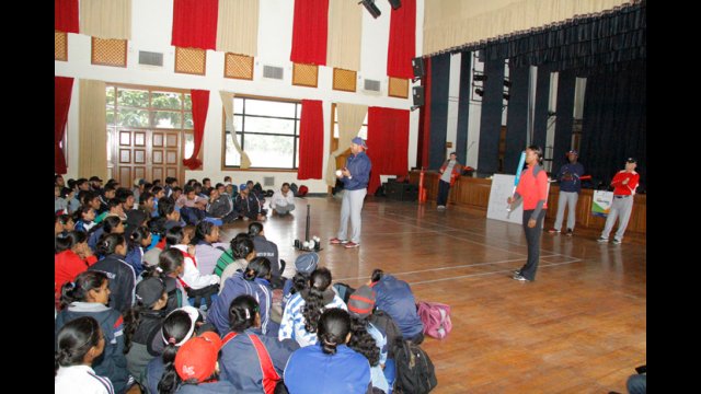  The team listens to Barry Larkin as he shares tips on different baseball techniques. 