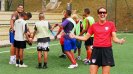 Brandi Chastain shows her enthusiasm for the teenage boys team as they engage in team building activities.
