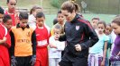 Brandi Chastain demonstrates some of her favorite warm-up moves to a group of youth participants during a training clinic near São Paulo.