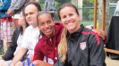 Brandi Chastain poses with Rosana dos Santos Augusto at a Soccer Festival in celebration of the positive things that come with participation in sports.