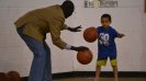 One of the coaches from South Sudan works on dribbling drills with a young athlete in Washington, D.C.