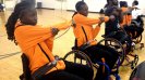 The Senegalese delegation stretches before participating in a disability sport activity with members of a wheelchair basketball league in Washington, D.C.