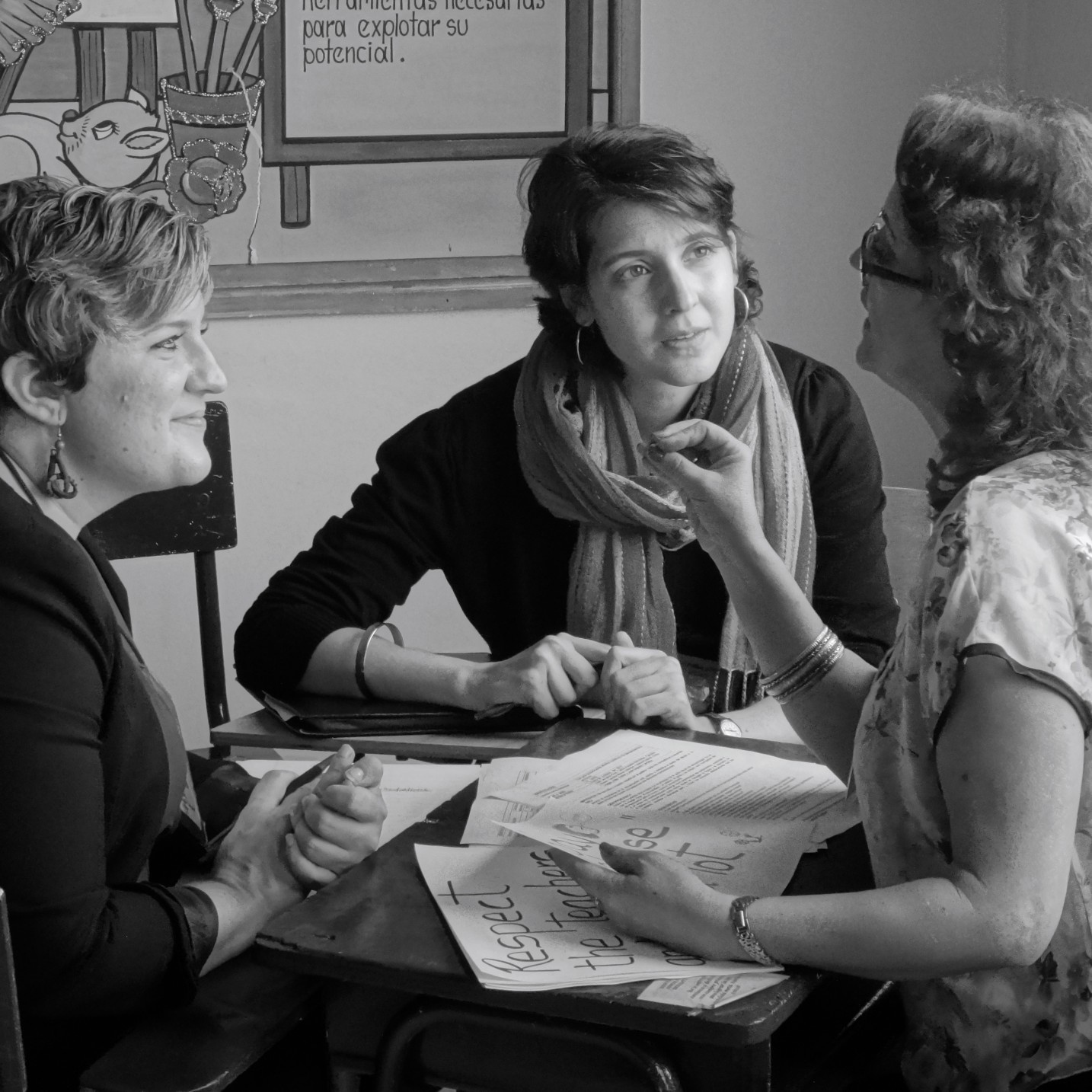 Two listening to third woman talking.