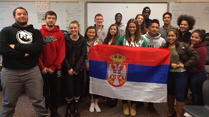 Serbian exchange student Dunja Paunovic poses with the Serbian flag and her new friends at her host school in Seattle, Washington.