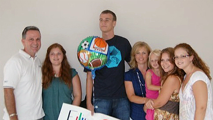 The Parkers pose together after celebrating A-SMYLE student Filip’s basketball success (L to R: Neal, Michaela, Filip, Leigh Ann, McKinnon, Jenia, and Lauren). Photo courtesy of Leigh Ann Parker.