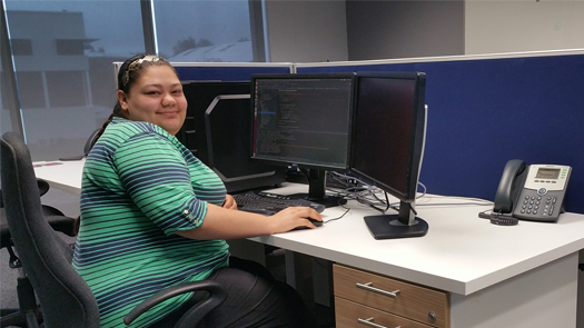 Woman seated in front of a computer in an office