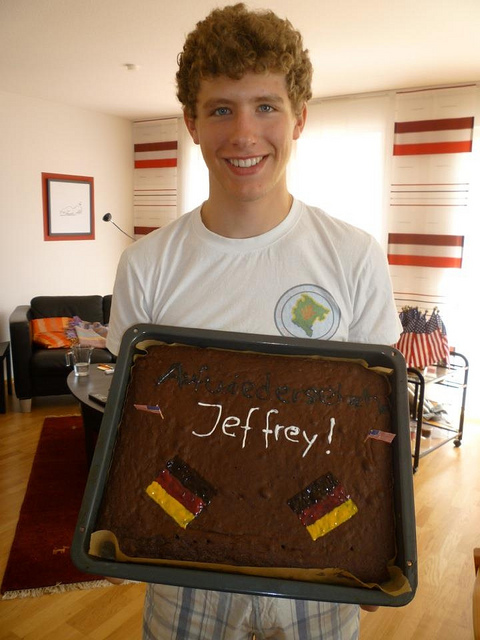 Jeffrey holding a ‘goodbye’ cake at the end of his exchange program.