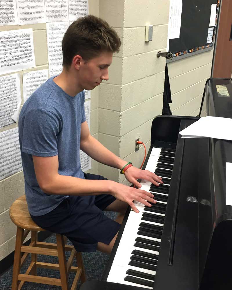 Young man playing a piano