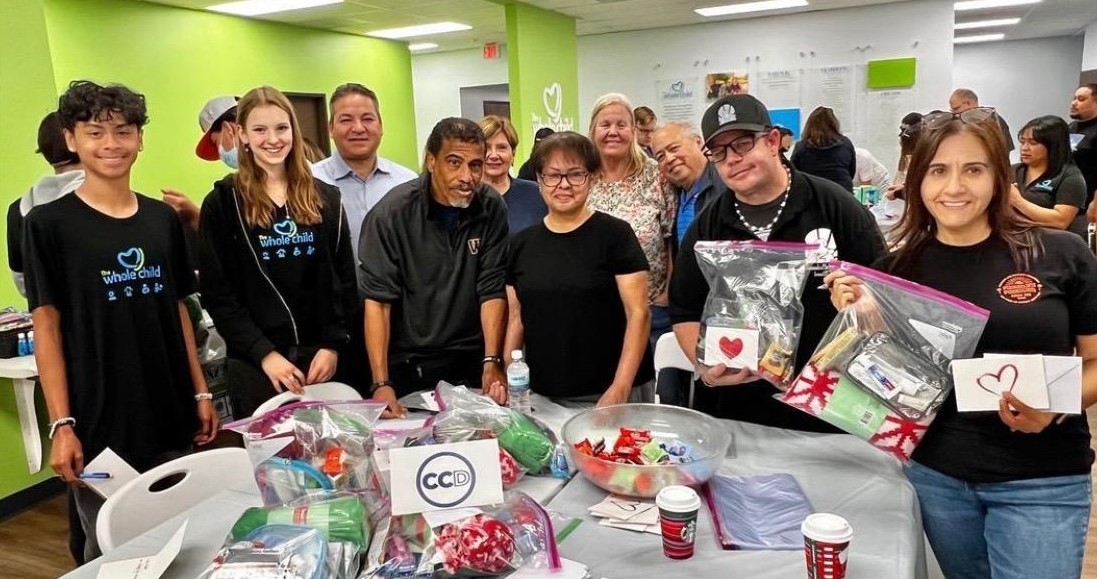 Friederike and fellow volunteers pose with their care packages created for a charity event