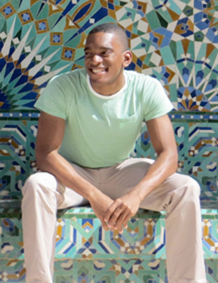 Young man sitting on colorful bench