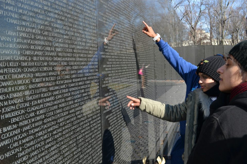 During their tour of Washington, D.C., the group takes time to absorb the significance of the Vietnam War Monument.