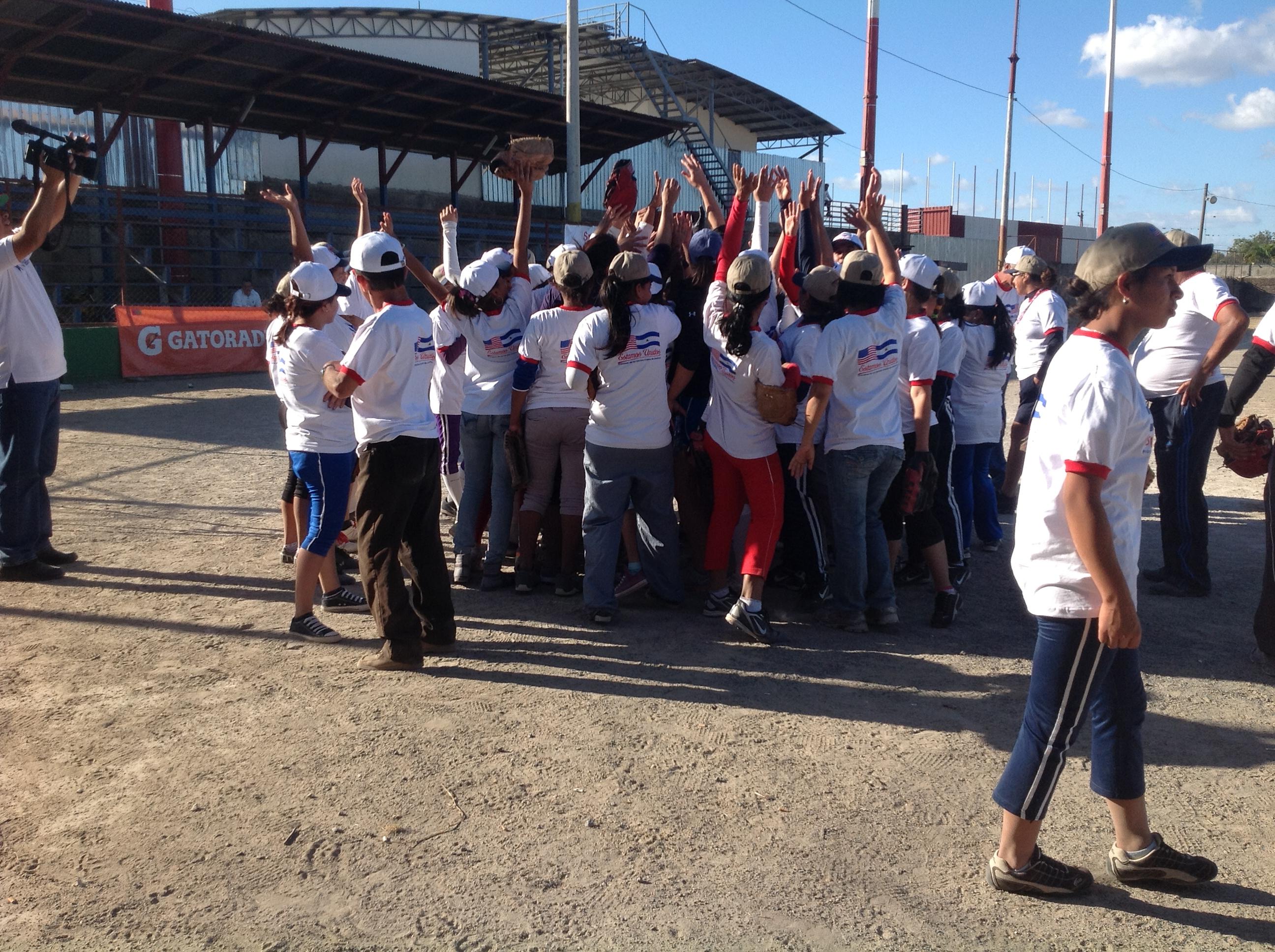 After an invigorating game, Nicaraguan players celebrate the sport of softball with a group cheer.