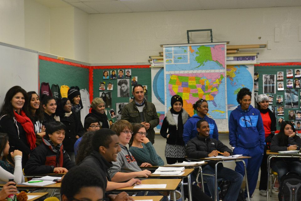 The group attends a high-school history class to learn about the U.S. school system.