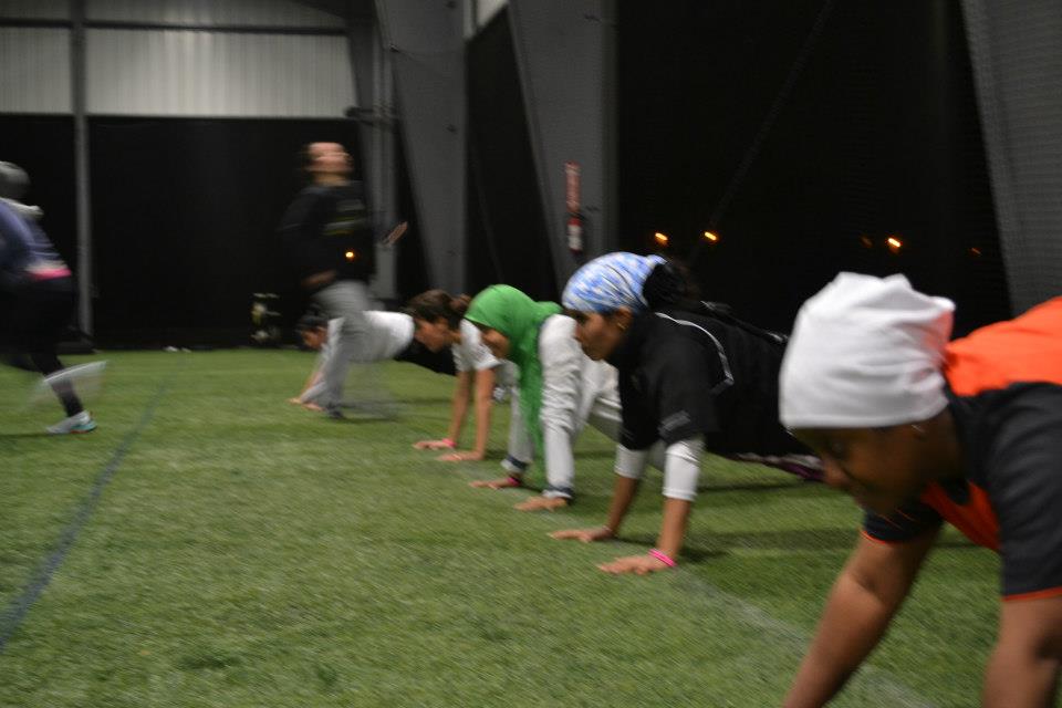 The volleyball coaches from the Gulf Nations stay strong throughout a challenging workout.