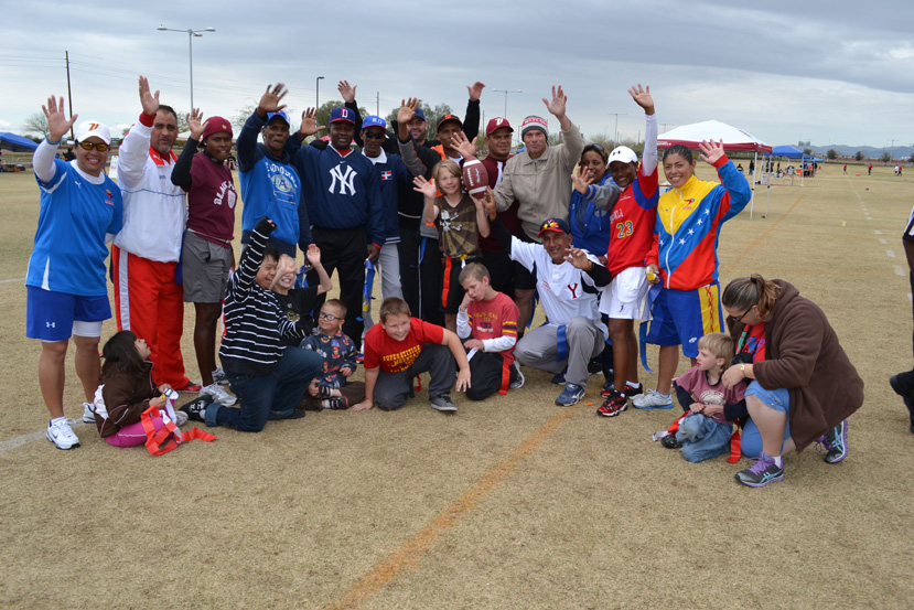 The coaches pose with representatives of a local-area sports group.