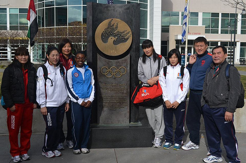 Mongolian wrestlers pose at the Olympic Truce statue in Colorado.