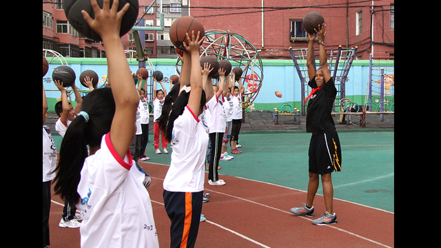 Kiesha Brown teaches ball handling to the girls from Shenhe Migrant Workers Elementary School in China.