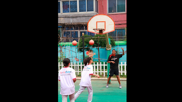 Kiesha Brown leads a shooting drill with girls from the Shenhe Migrant Workers Elementary School in China.