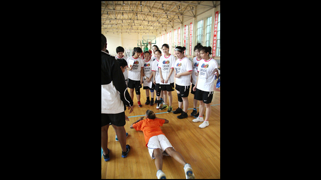 Tamika Raymond and Kiesha Brown speak on injury prevention with the girls basketball team at Baode Junior High School in China.