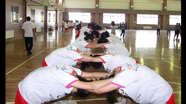 The girls warm up for a clinic at Guangquan Rural School in China.