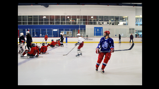 The Russian visitors scrimmage against the sled team.