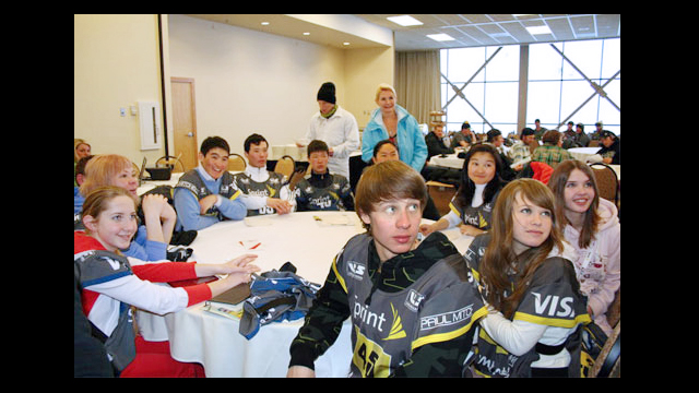 The participants from Kyrgyzstan receive bibs from the USSA as honorary participants in the Grand Prix.