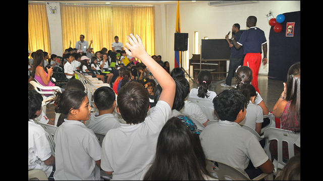 Barry Larkin and Joe Logan interact with girls and boys at Colegio Americano in Ecuador.
