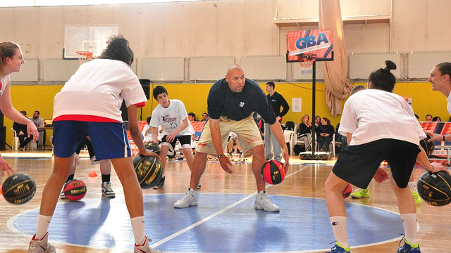 NBA’s Tracy Murray leads a ball handling drill with young players during a clinic in Thessaloníki, Greece.