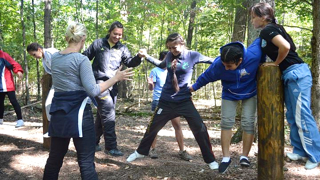 The coaches work together in a team building activity.