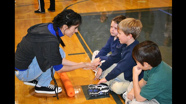 The coaches interact with American students at a local elementary school. 