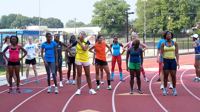 The Caribbean track and field delegation lines up to run sprints during a practice with Arlington Pacer’s coach Dustin Sweeney.