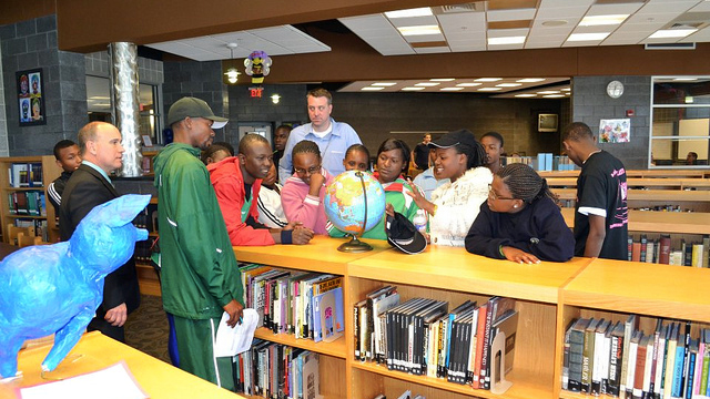 The group points out their home countries on the globe during their visit to a local high-school in Maryland.