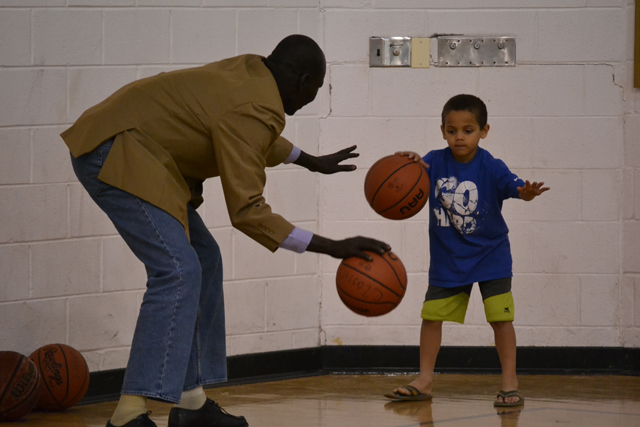 One of the coaches from South Sudan works on dribbling drills with a young athlete in Washington, D.C.