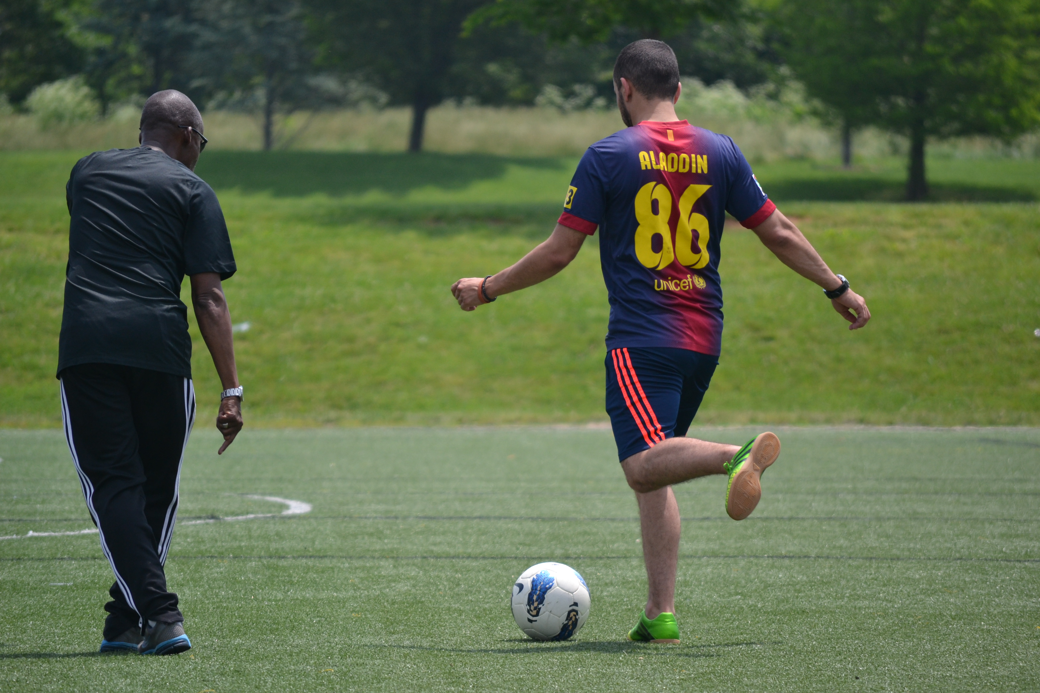 U.S coach/trainer works with a NEA coach on a passing drill.