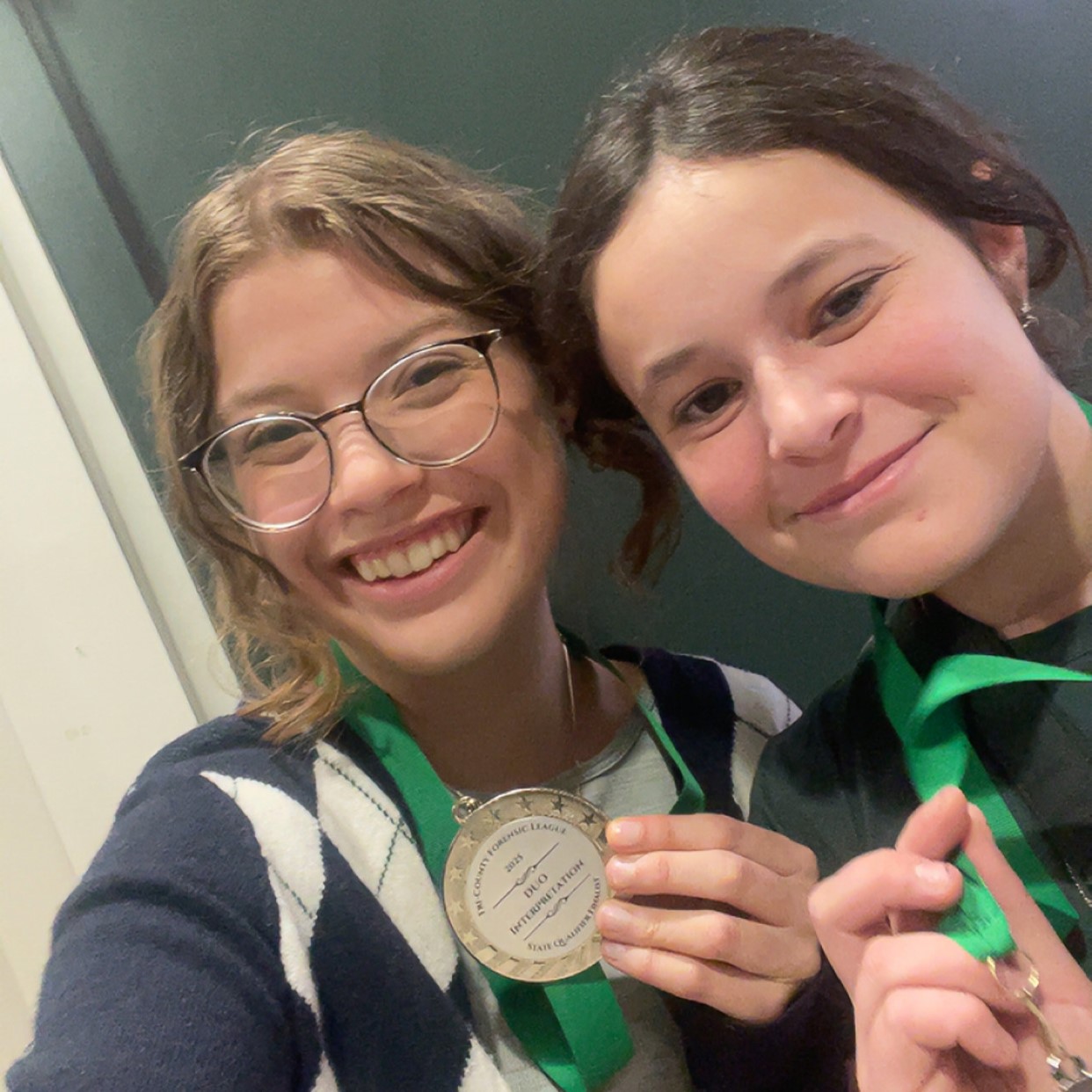 Jara and her Speech and Debate partner show off their medals from the Tri-County Forensic League State Championship Competition in California. 