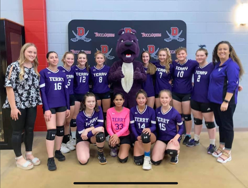 Jeremy dressed as a purple dog team mascot with the team 
