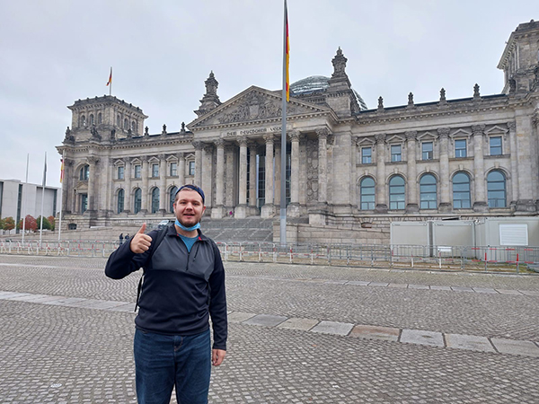 Image of Nolan in front of a building