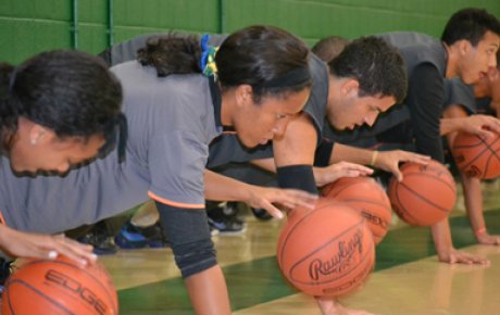  The Brazilian visitors work on dribbling by performing one-handed push-ups.