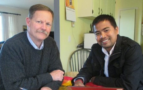 John and Chhunn pose for a photo.