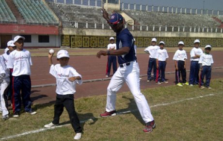 Joe Logan assists team members with their fast pitch.