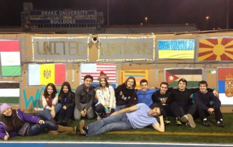 Group of students pose on the infield of the Drake University track