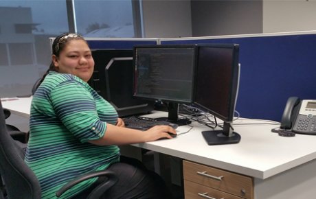 Woman seated in front of a computer in an office